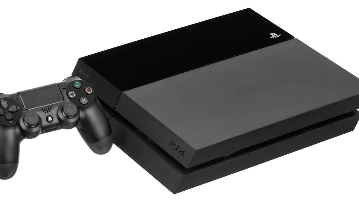 A black PlayStation 4 console with a DualShock 4 controller beside it on a white background